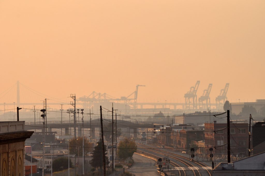 A view of the Port of Oakland through smoky skies