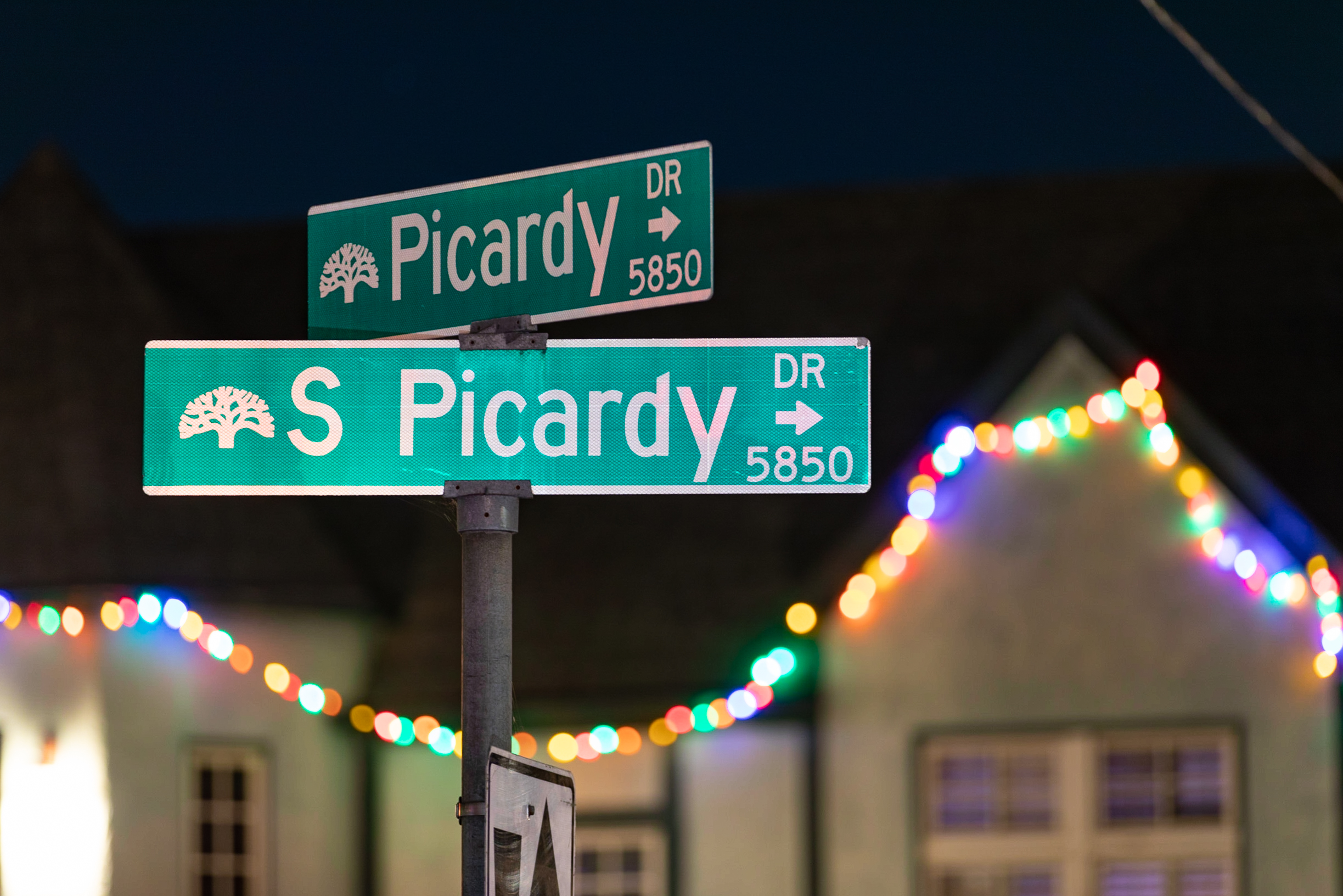 Picardy Dr street sign and Christmas decorations covering the house Picardy Drive residents.