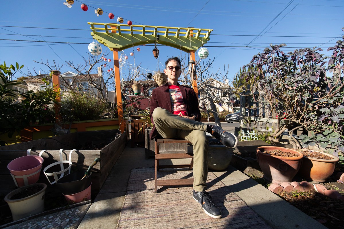 Alexey Berlind, musician, sits outside of his home in Oakland, California