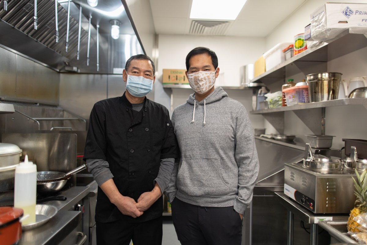 Father and son co-owners, Sheguang Zao and Dan Zhao respectively, in their ghost kitchen work space for Cozy Wok, a vegetarian and vegan Chinese restaurant.