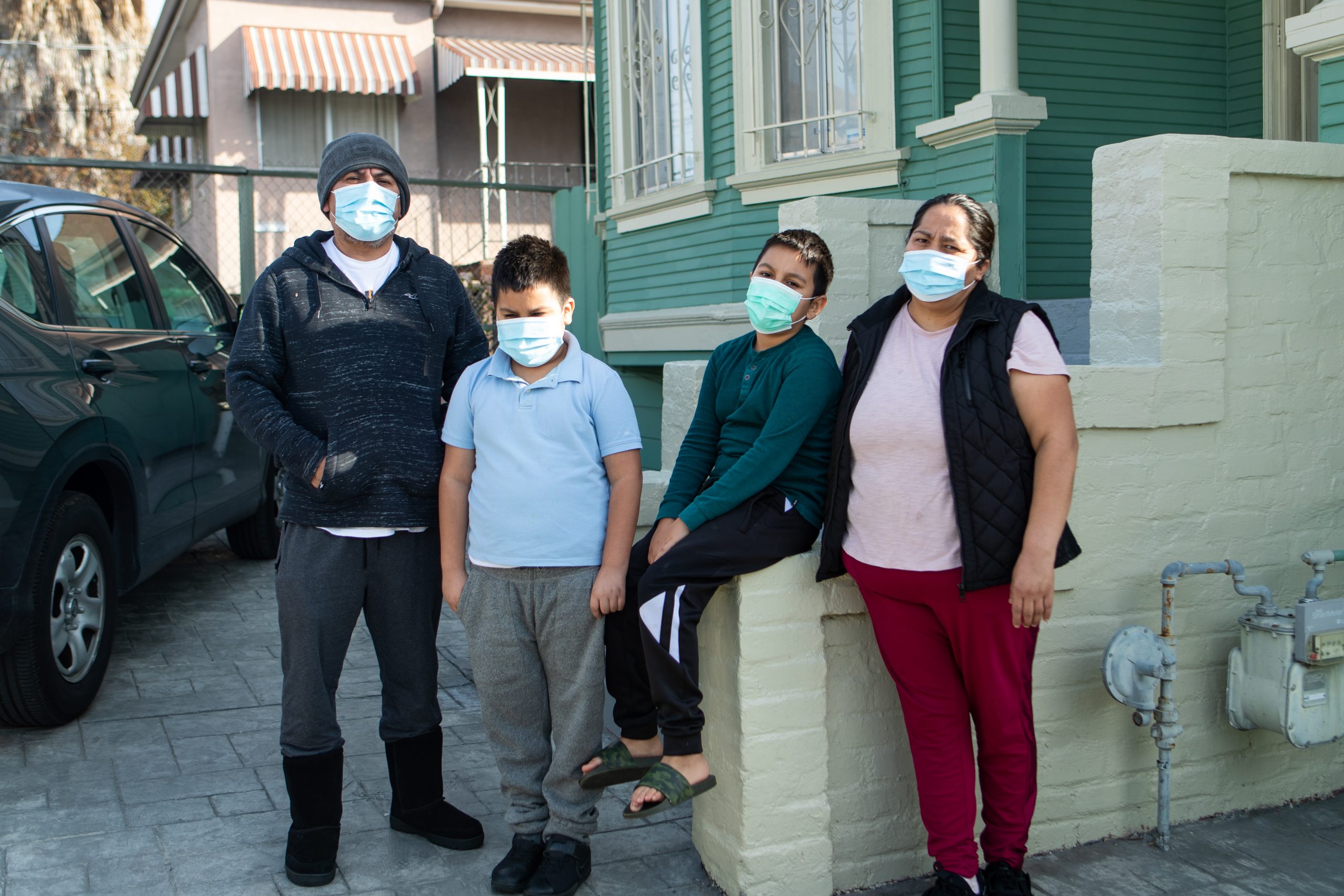 Maria González and her family in front of their home in East Oakland.
