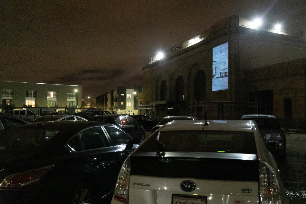 Cars parked at the 16st Street train station watching the projected movie