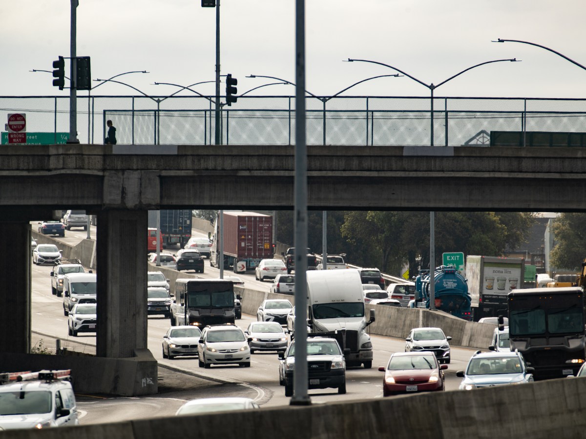Semitrucks ride along Interstate 880 freeway in East Oakland