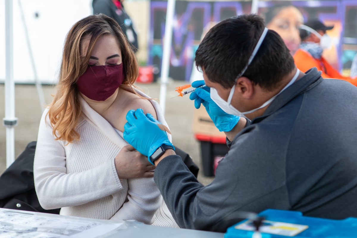 Itzel Diaz, an essential worker at Unity Council gets her second dose of vaccine from the Native Ameican Health Center site in Fruitvale.