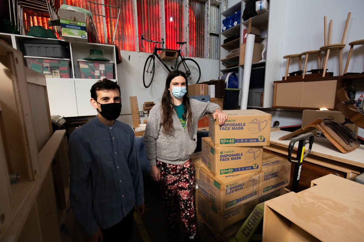 Mask Oakland organizers, Quinn Jasmine Redwoods and Dennis Uyat moving donated masks from a holding facility.