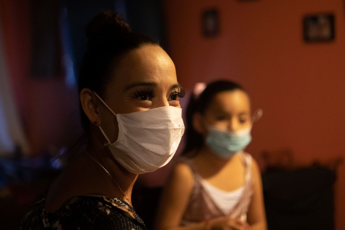 Guadalupe Muñoz with her daughter Carla in their East Oakland apartment. Mold and other problems have contributed to Carla's asthma.