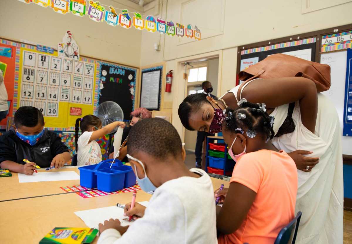 Oakland Unified School District Superintendent Kyla Johnson-Trammell talked with kindergarten students at Lockwood STEAM Academy on the first day of school. Face masks are mandatory, and on Aug. 11 Gov. Newsom announced all school staff must be vaccinated or tested.