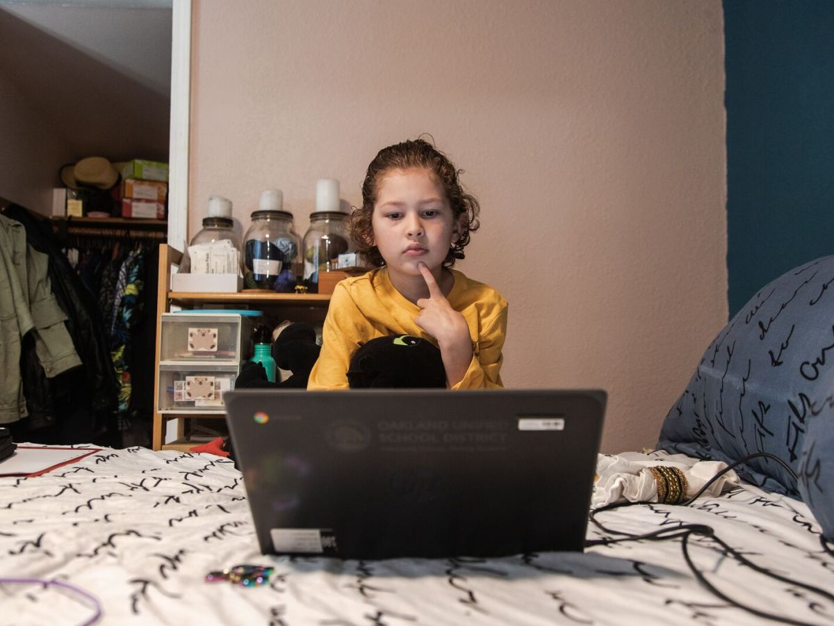 six-year-old child using laptop for school