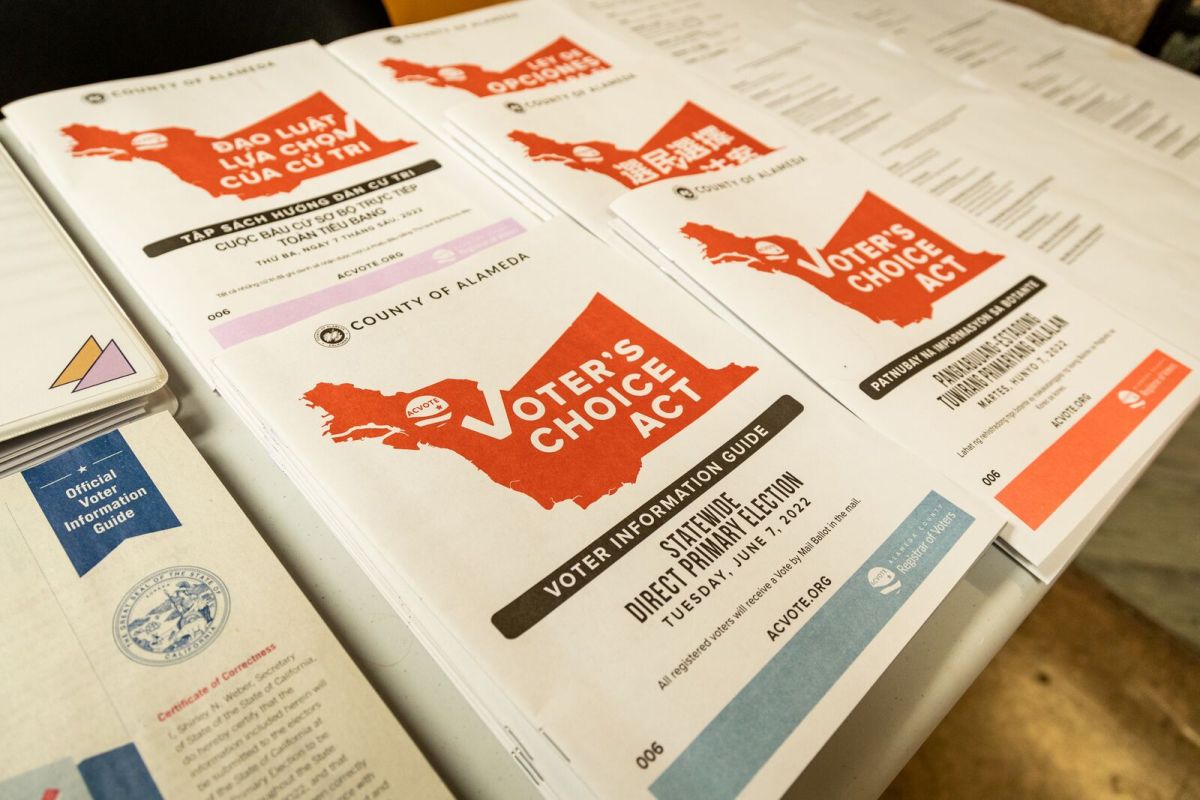 Voter guides stacked on a table