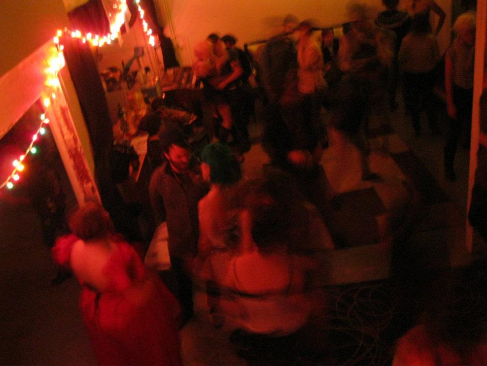 Blurry red picture of a packed party