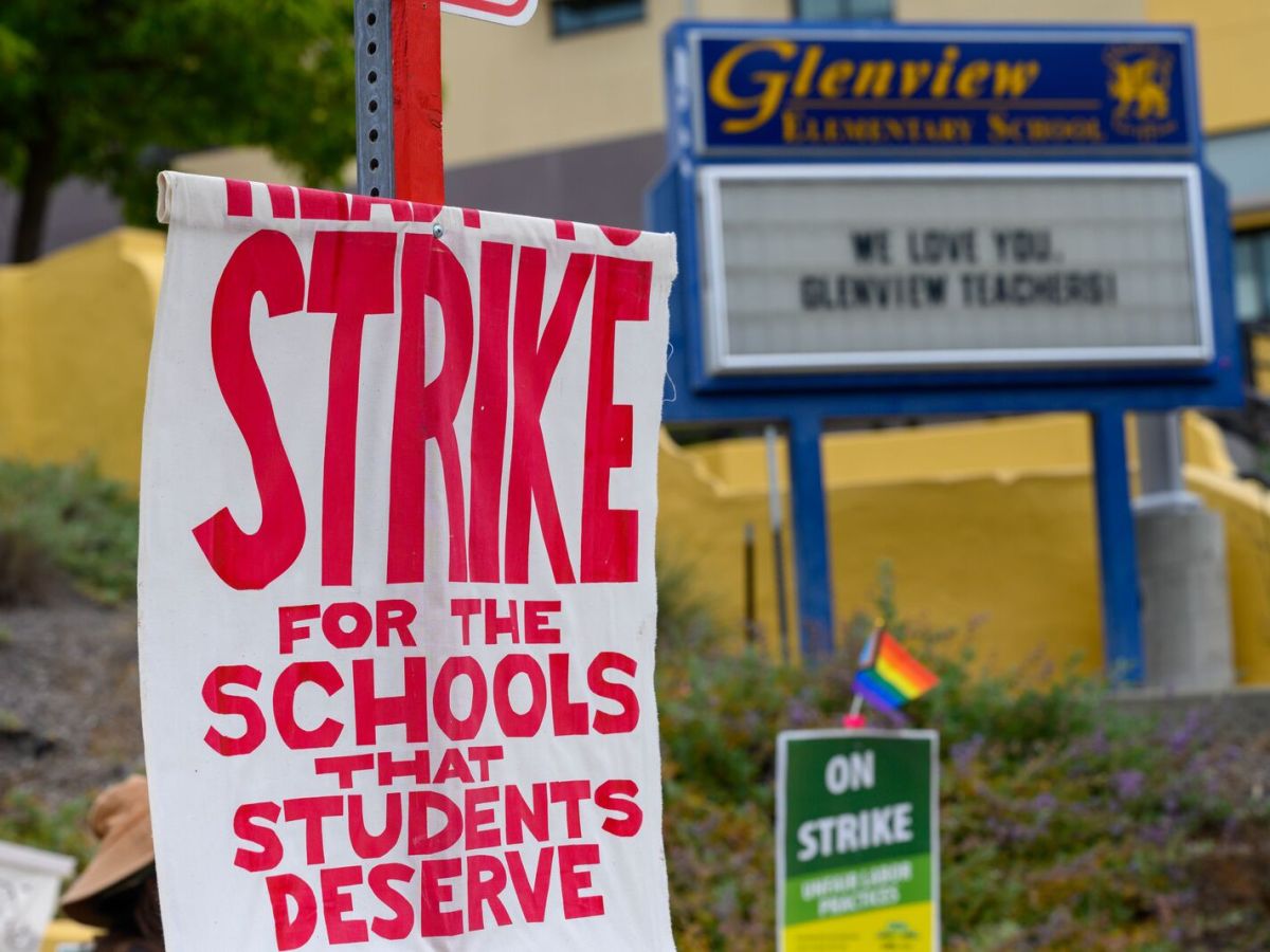 A sign with "Strike for the schools that students deserve" on display in front of Glenview elementary marquee, which reads "We love you, Glenview teachers!"