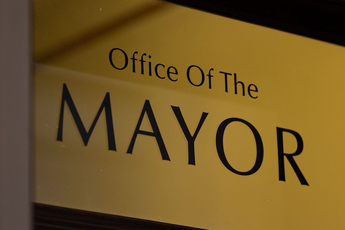 A gold plaque that says Office Of The Mayor.