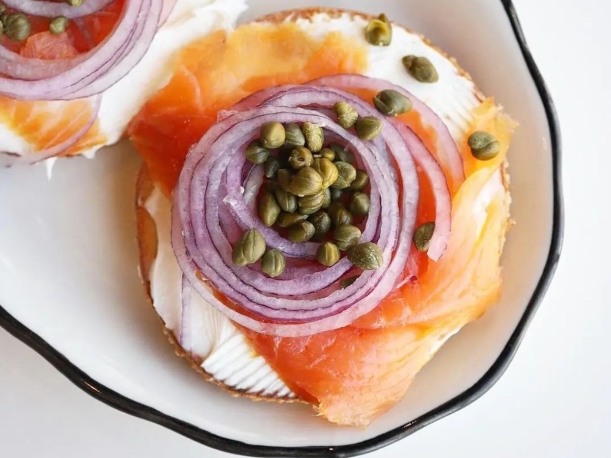 Open lox bagel with red onions and capers