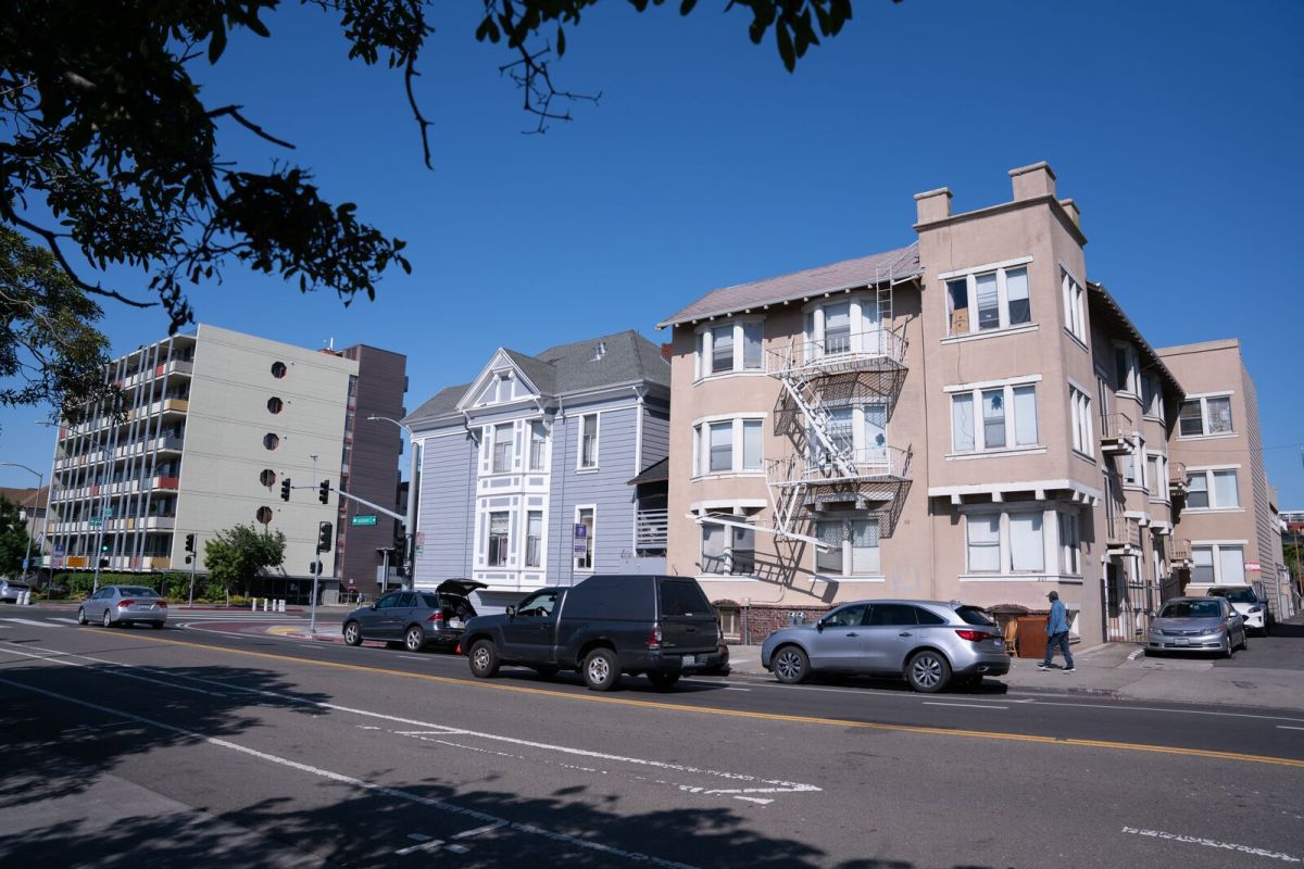 Older and newer apartment buildings on a busy street in Oakland.