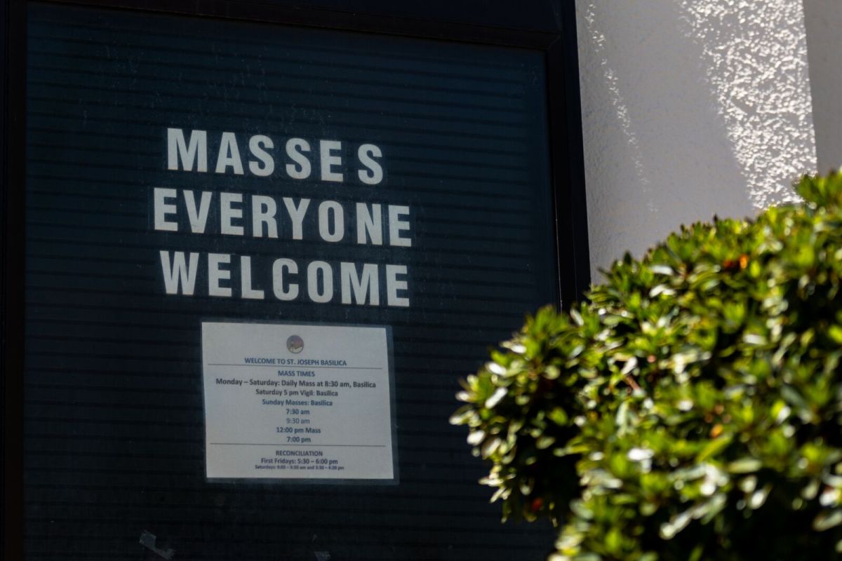 A sign outside St. Joseph's Basilica in Almada says "Masses everyone welcome."