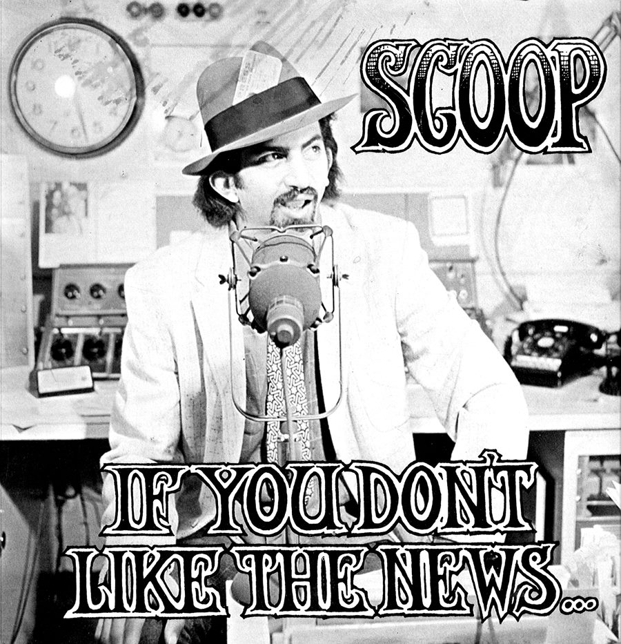 Nisker dressed in stereotypical news reporter clothing—suit and hat— talking into a microphone with the words "Scoop" and "If you don't like the news..."