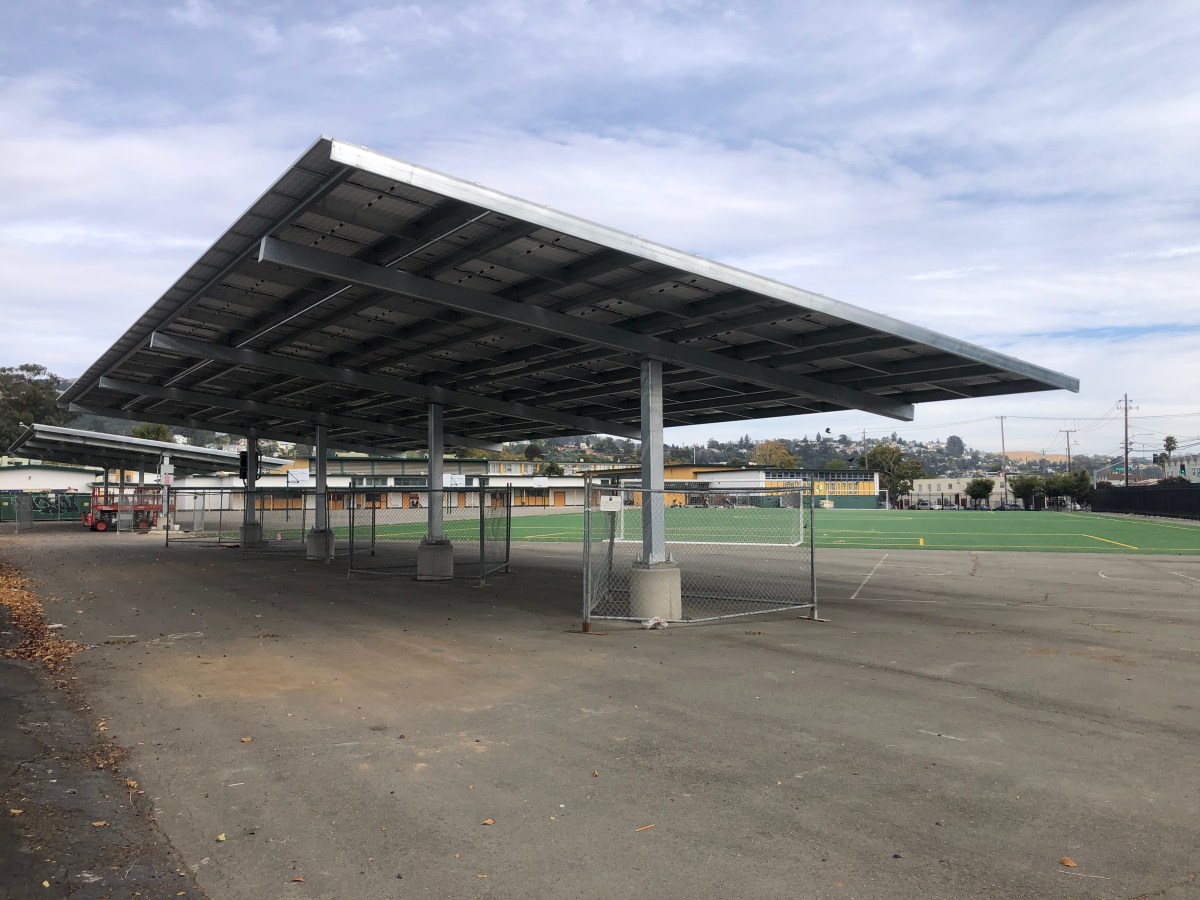 Large solar panel system above a school parking lot in Oakland.