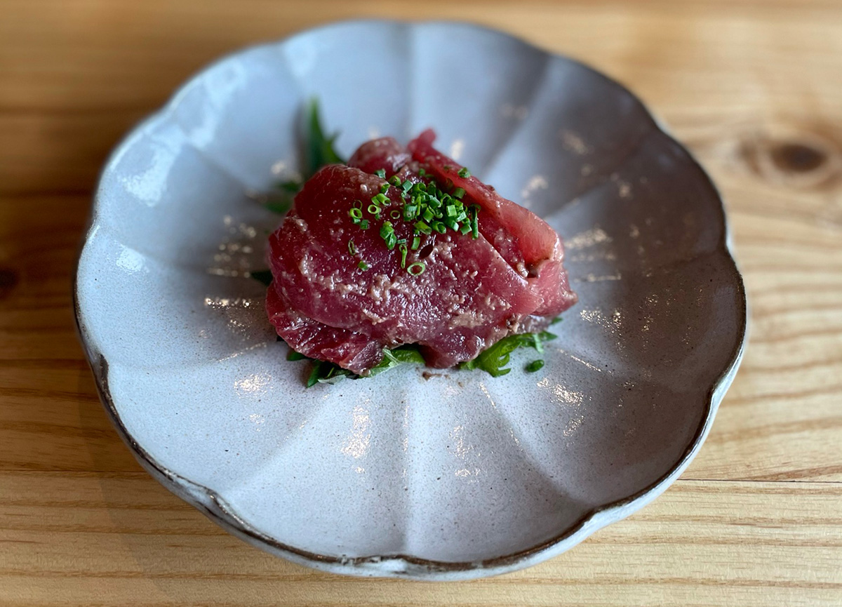 A white plate with a blue rim holds bluefin tuna from Sushi Salon